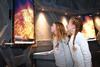 Two girls look on at news footage in awe as part of National Space Centre's Mission to Mars