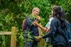 A member of staff at Wakehurst botanic garden with school students