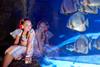 Girl with headset looking into underwater exhibit