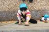 A girl climbs a wall at Avon Tyrrell Outdoor Centre