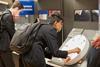 A student leans over an interactive museum exhibit