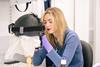 Woman investigating historic item with gloves