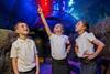 Three young schoolchildren look at sea life in one of the SEA LIFE centres