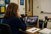 Teacher watching a webinar