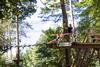 A young boy enjoys a zip wire at a Go Ape forest
