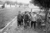 Photograph showing children playing with fake bayonets during WWI
