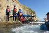 Child jumping into the sea at Land & Wave in Dorset