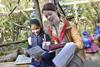 School child discussing animals at London Zoo with a teacher during educational visit