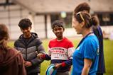 Children are led in an activity by a PGL instructor