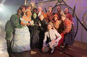 The West End cast of Wicked pose with their School Travel Award on stage at the Apollo Victoria Theatre