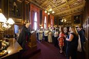 A man gives a lecture to a room full of people in Parliament