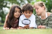 Children with magnifying glass