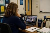 Teacher watching a webinar