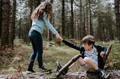 Children helping each other in nature