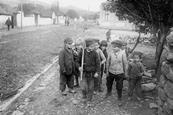 Photograph showing children playing with fake bayonets during WWI