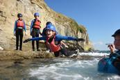 Child jumping into the sea at Land & Wave in Dorset