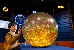 Young boy interacts with Sun installation