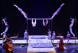 Acrobats perform on bars as part of Cirque du Soleil's performance of Corteo
