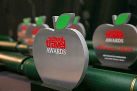 School Travel Awards trophies lined up on a table.
