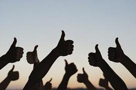 Silhouette of people's hands with thumbs up