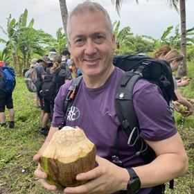 Teacher Lee Gwillim holding a coconut