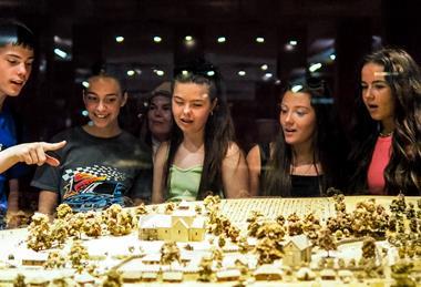 Students look at a model during a school trip to Normandy, France.
