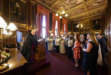 A man gives a lecture to a room full of people in Parliament