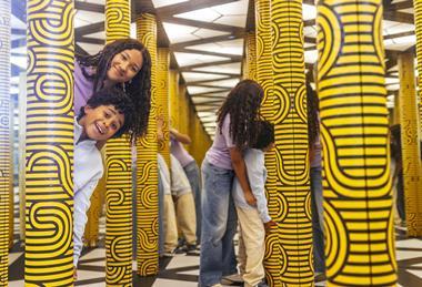 Two kids in a mirror maze
