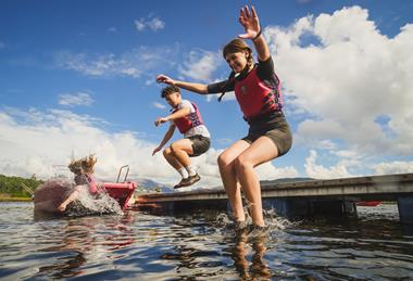 Pupils jumping into water on an Outward Bound Trust residential