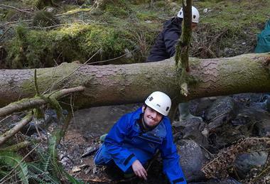 A student climbing on rocks