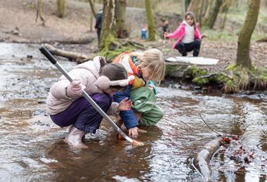 Students taking part in pond dipping as part of a Conway Centres residential