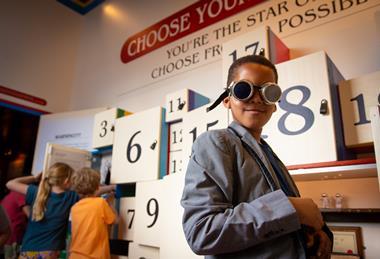 Young boy wears goggles at The Story Museum
