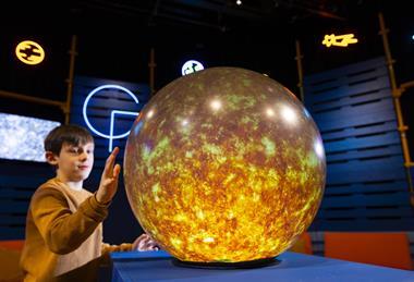 Young boy interacts with Sun installation