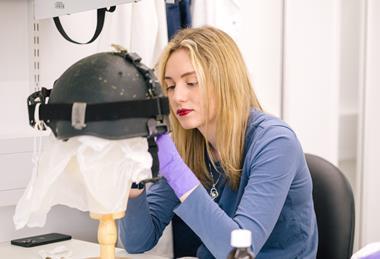 Woman investigating historic item with gloves