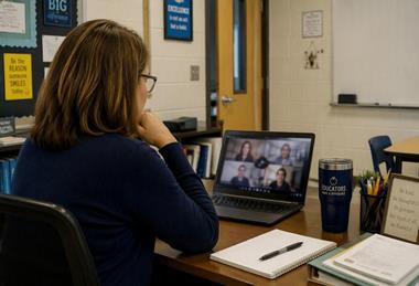Teacher watching a webinar