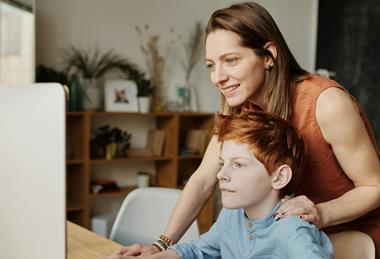 A parent with a child in front of the computer