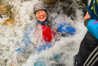 One pupil immersed in water on an Outward Bound Trust residential