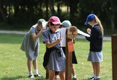 Pupils doing worksheets in an outdoor exhibit