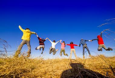 Kids jumping on hill