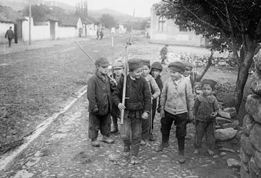 Photograph showing children playing with fake bayonets during WWI