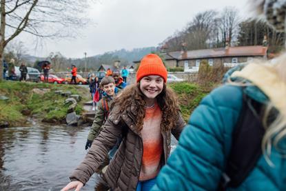 Pupils crossing the river on a school trip