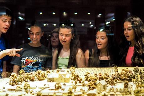 Students look at a model during a school trip to Normandy, France.
