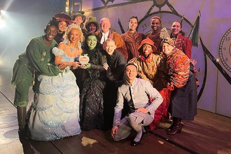 The West End cast of Wicked pose with their School Travel Award on stage at the Apollo Victoria Theatre