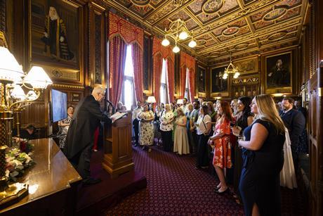A man gives a lecture to a room full of people in Parliament