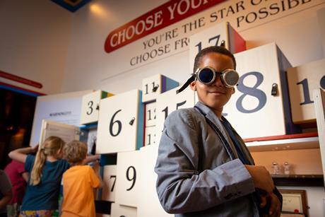 Young boy wears goggles at The Story Museum