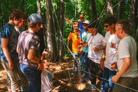 Students problem solving on their screen free outdoor adventure with Mendip Activity Centre