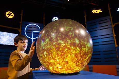 Young boy interacts with Sun installation