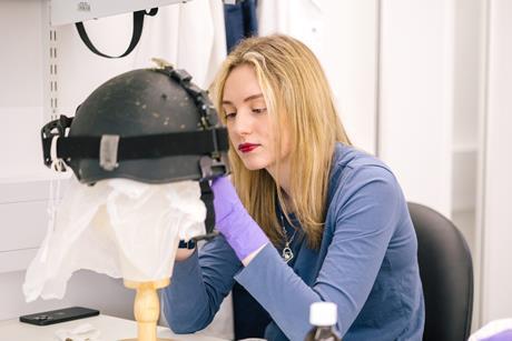 Woman investigating historic item with gloves