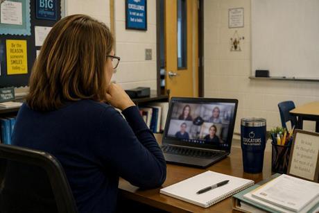 Teacher watching a webinar