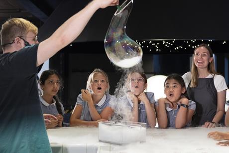 KS2 group watching a live experiment at the Chemistry Bar in Wonderlab, Science Museum.